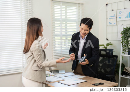 Professional Exchange. Colleagues sharing insights in a modern office. Professional Exchange. Colleagues sharing insights in a modern office. 126803816