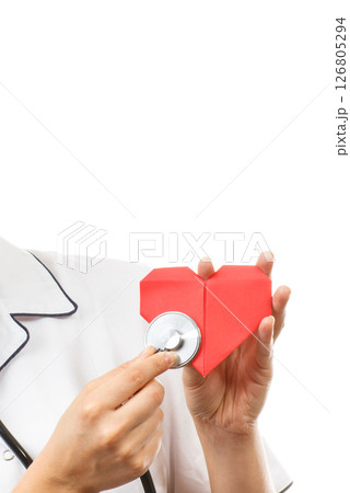 Hand of doctor with stethoscope examining red heart made of paper. Health care and treatment Hand of doctor with stethoscope examining red heart made of paper. Health care and treatment 126805294