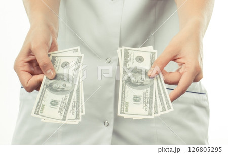 Doctor with dollars. Corruption, bribe or paying for health care or or examination Doctor with dollars. Corruption, bribe or paying for health care or or examination 126805295