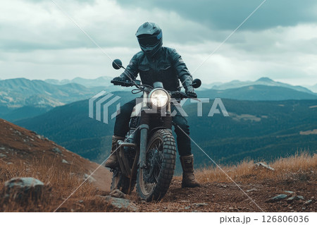 Extreme rider on a mountain top on off-road cross enduro motorcycle. Extreme rider on a mountain top on off-road cross enduro motorcycle. 126806036
