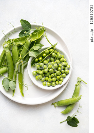 Fresh green peas beans in a white plate, copy space 126810783