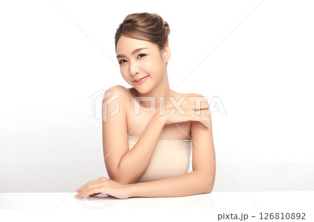 A beautiful young Asian woman with clean, fresh skin against a white background. Skincare, facial treatment, cosmetology, beauty, and spa. An elegant portrait of an Asian woman. 126810892
