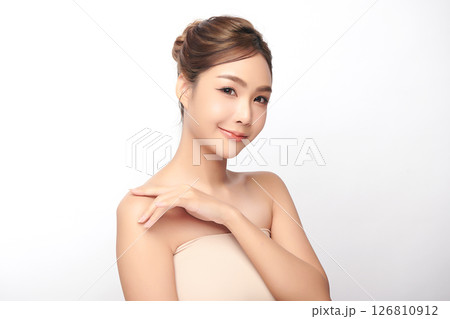 A beautiful young Asian woman with clean, fresh skin against a white background. Skincare, facial treatment, cosmetology, beauty, and spa. An elegant portrait of an Asian woman. 126810912