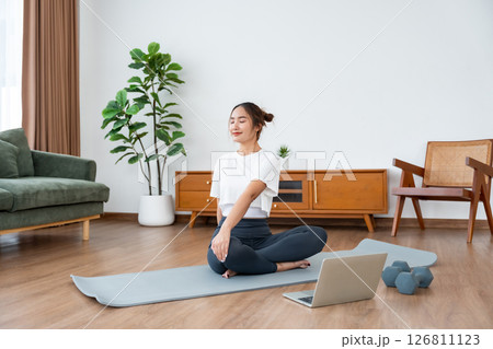 Young Asian woman stretching yoga workout on exercise mat Young Asian woman stretching yoga workout on exercise mat 126811123