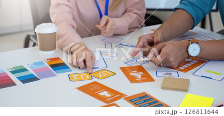Collaborative Design Meeting. Professionals discussing and reviewing design concepts and color palettes. 126811644