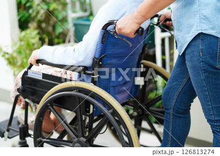 Caregiver help Asian elderly woman disability patient sitting on wheelchair in hospital. Caregiver help Asian elderly woman disability patient sitting on wheelchair in hospital. 126813274