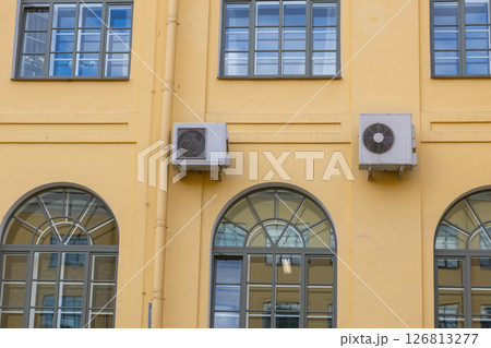 Air conditioning on facade of the building. air-to-air heat pump for cooling or heating the house. Air conditioning on facade of the building. air-to-air heat pump for cooling or heating the house. 126813277