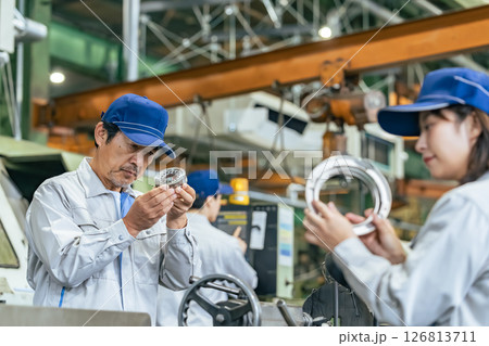 工場で製品を検品する作業員グループ 工場で製品を検品する作業員グループ 126813711