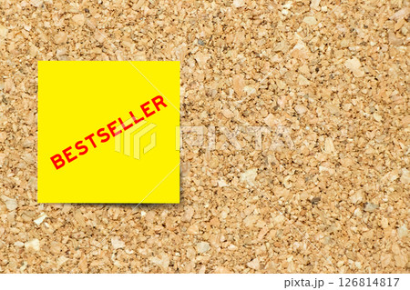 Yellow note paper with word bestseller on cork board background with copy space 126814817