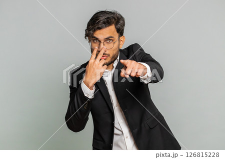 Business man pointing at her eyes camera show I am watching you gesture spying watching on someone 126815228
