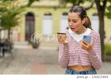 Shocked woman trying pay online shopping with smartphone blocked credit card lack of money balance 126815804