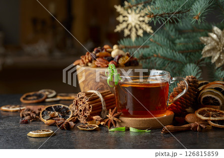 Tea with spices and dry fruits on a kitchen table. 126815859
