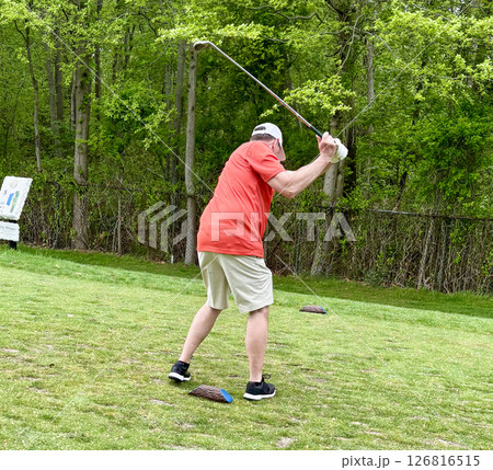 Golf Swing Captured on a Sunny Day in a Serene Green Setting 126816515