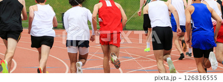 A Large Group of Runners Competing in a Track Race Outdoors 126816555