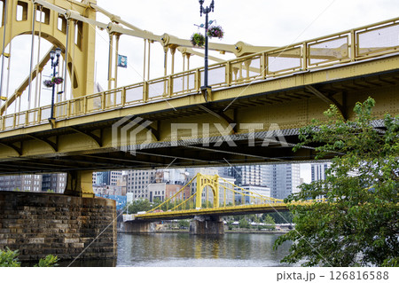 Looking up at Golden Bridges Spaning Across River With the City of Pittsburgh Skyline in Background 126816588