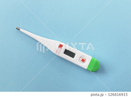 White digital thermometer for temperature measurement on beige background. 126816915