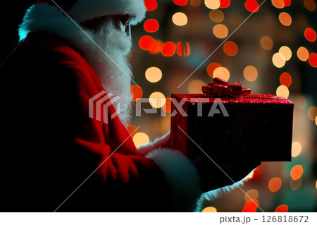 Close up shot of a santa clause outfit carrying gift box. christmas spirit, holiday mood Close up shot of a santa clause outfit carrying gift box. christmas spirit, holiday mood 126818672