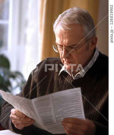 man reviewing retirement plan documents, 126819902