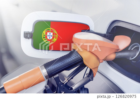 Portugal flag on the lid of the gas tank of a car at a gas station in close-up. High or low prices for gasoline and diesel fuel at Portuguese gas stations. fuel shortage for cars in Portugal. Portugal flag on the lid of the gas tank of a car at a gas station in close-up. High or low prices for gasoline and diesel fuel at Portuguese gas stations. fuel shortage for cars in Portugal. 126820975