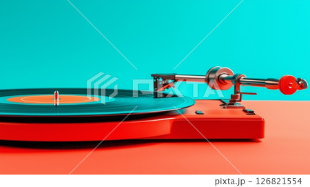 Vintage red turntable playing vinyl record on vibrant turquoise background 126821554