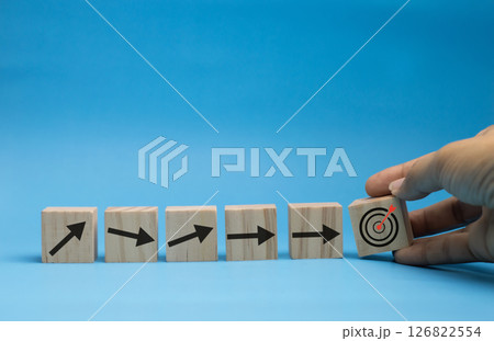 Concept of wooden blocks with arrows shooting straight to the target. 126822554