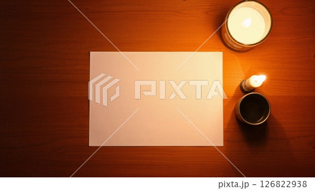 Art photo of desk with paper. Candlelight warms the wood, smooth texture. Art photo of desk with paper. Candlelight warms the wood, smooth texture. 126822938