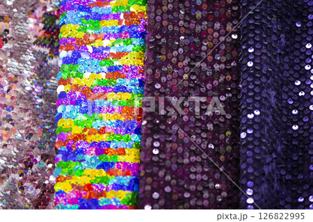 Multi-colored canvases of fabric with rhinestones of the same texture. Textile production. 126822995