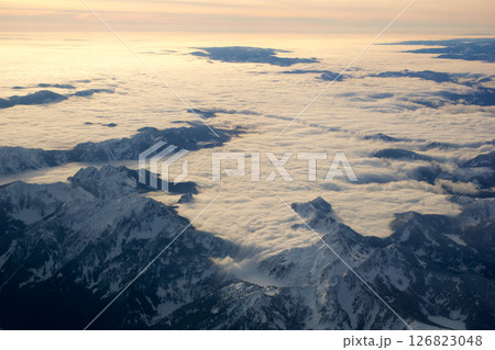 Seattle, USA, January 27, 2017: Snow-Covered Mountains Partially Hidden by Clouds After Takeoff 126823048