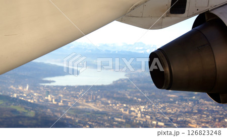 Zurich, Switzerland, April 15, 2015: BAe 146 Wing View over Swiss Landscape Zurich, Switzerland, April 15, 2015: BAe 146 Wing View over Swiss Landscape 126823248