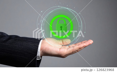 Businessman hand holding digital secure lock icon with holographic security circle representing data protection and cybersecurity concept 126823968