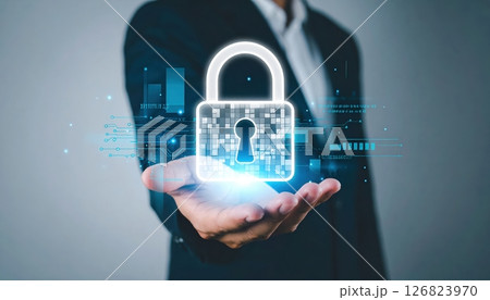 Businessman holding digital lock icon hologram representing cybersecurity and data protection concept 126823970