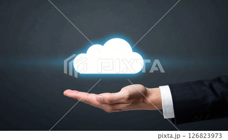 Businessman holding a glowing cloud icon representing cloud computing and data storage technology 126823973