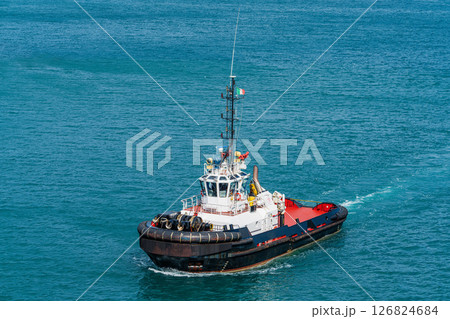 Tugboat sailing in open sea Tugboat sailing in open sea 126824684