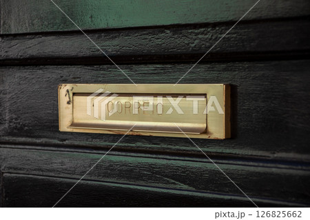 Close-up of a brass Correio mail slot on a black wooden door Close-up of a brass Correio mail slot on a black wooden door 126825662