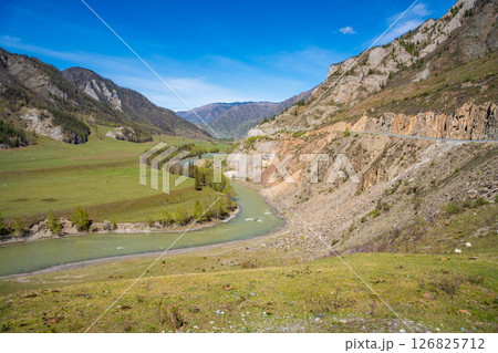 Aerial view of Chuya River flowing between mountains in Chuysky Trakt area Altai Russia. Scenic Siberian river valley surrounded by rugged terrain. 126825712