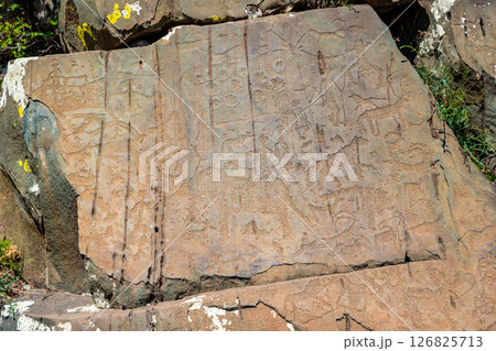 Petroglyphs at Kalbak-Tash rock art complex Altai Russia. Ancient carvings showcasing prehistoric cultural heritage. 126825713