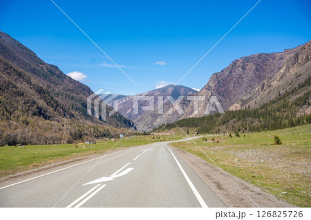 Road stretching along the Chuya River on Chuysky Trakt in Altai Russia. Scenic mountain route through wild Siberian landscape. 126825726