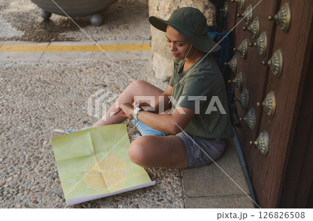 Traveler Exploring Medieval City with Detailed Map Outdoors Traveler Exploring Medieval City with Detailed Map Outdoors 126826508