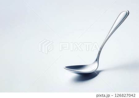 An elegant metal spoon ladle on a light background. Space for text. 126827042