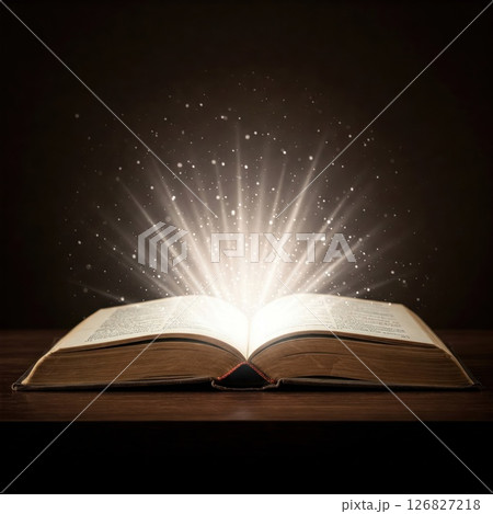 A magical light emanating from an open book. A magical light emanating from an open book. 126827218