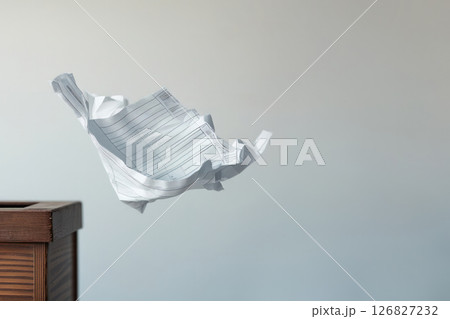 A paper sheet flies out of the trash can. Space for text. 126827232