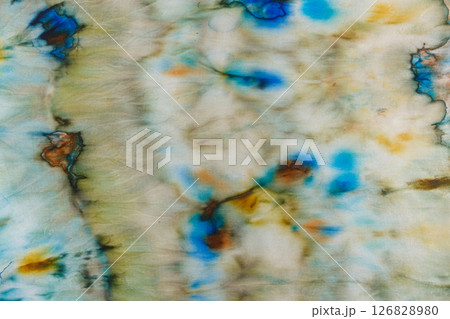 abstract pattern on silk fabric texture in blue, yellow, green colors abstract pattern on silk fabric texture in blue, yellow, green colors 126828980