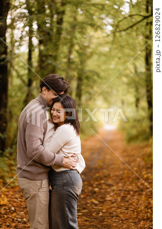 Happy couple embracing in autumn forest Happy couple embracing in autumn forest 126829024