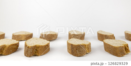 Freshly baked homemade baguette. Slices of bread are isolated on a white background. Concept of design elements. 126829329