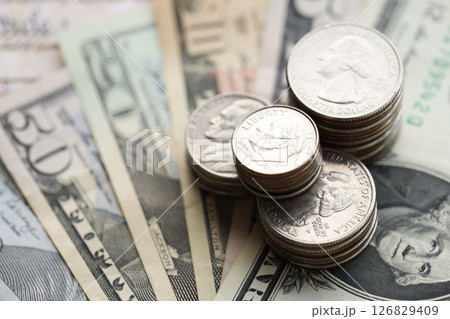 American US dollars money bills with coins and constitution close up on american flag 126829409