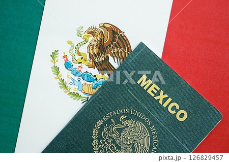 Mexican passport lies on Mexico flag close up. Travel and citizenship 126829457