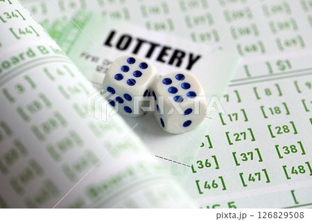 Lottery tickets and dice on blank bills with numbers for playing lottery 126829508