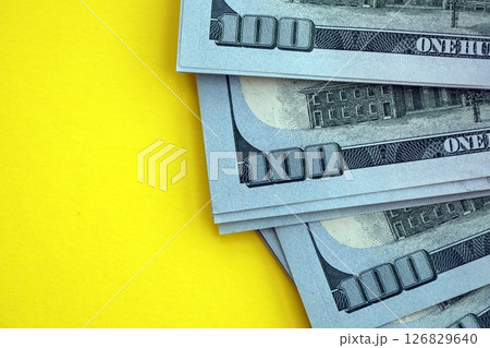 Big amount of United States hundred dollar bills on yellow background 126829640