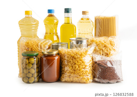 Foodstuff for donation isolated on white background with clipping path, storage and delivery. Various food, pasta, cooking oil and canned food in cardboard box. Foodstuff for donation isolated on white background with clipping path, storage and delivery. Various food, pasta, cooking oil and canned food in cardboard box. 126832588