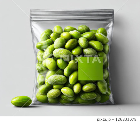 Transparent plastic bag filled with frozen edamame, featuring green label, isolated on white background. Transparent plastic bag filled with frozen edamame, featuring green label, isolated on white background. 126833079